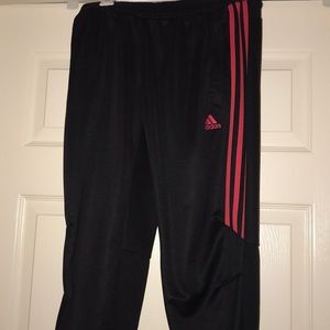 Black and pink striped adidas joggers.